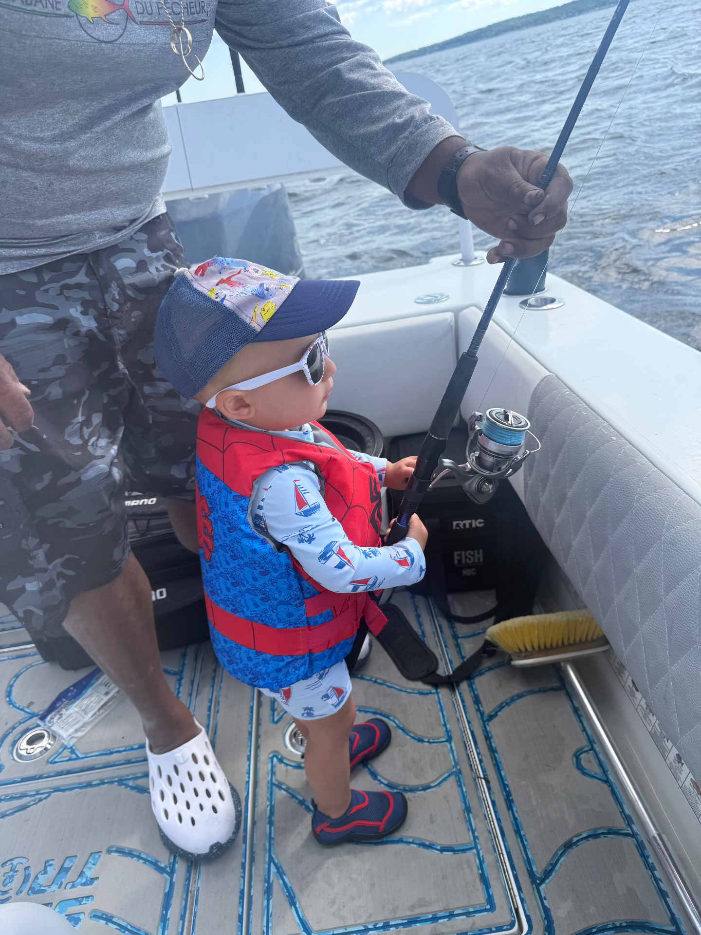 Little angler working a spinning rod with the captain