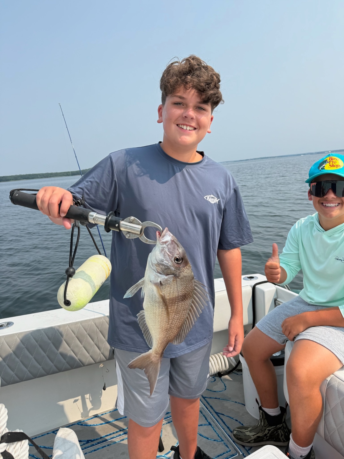 Academy camper with a scup and a thumbs up