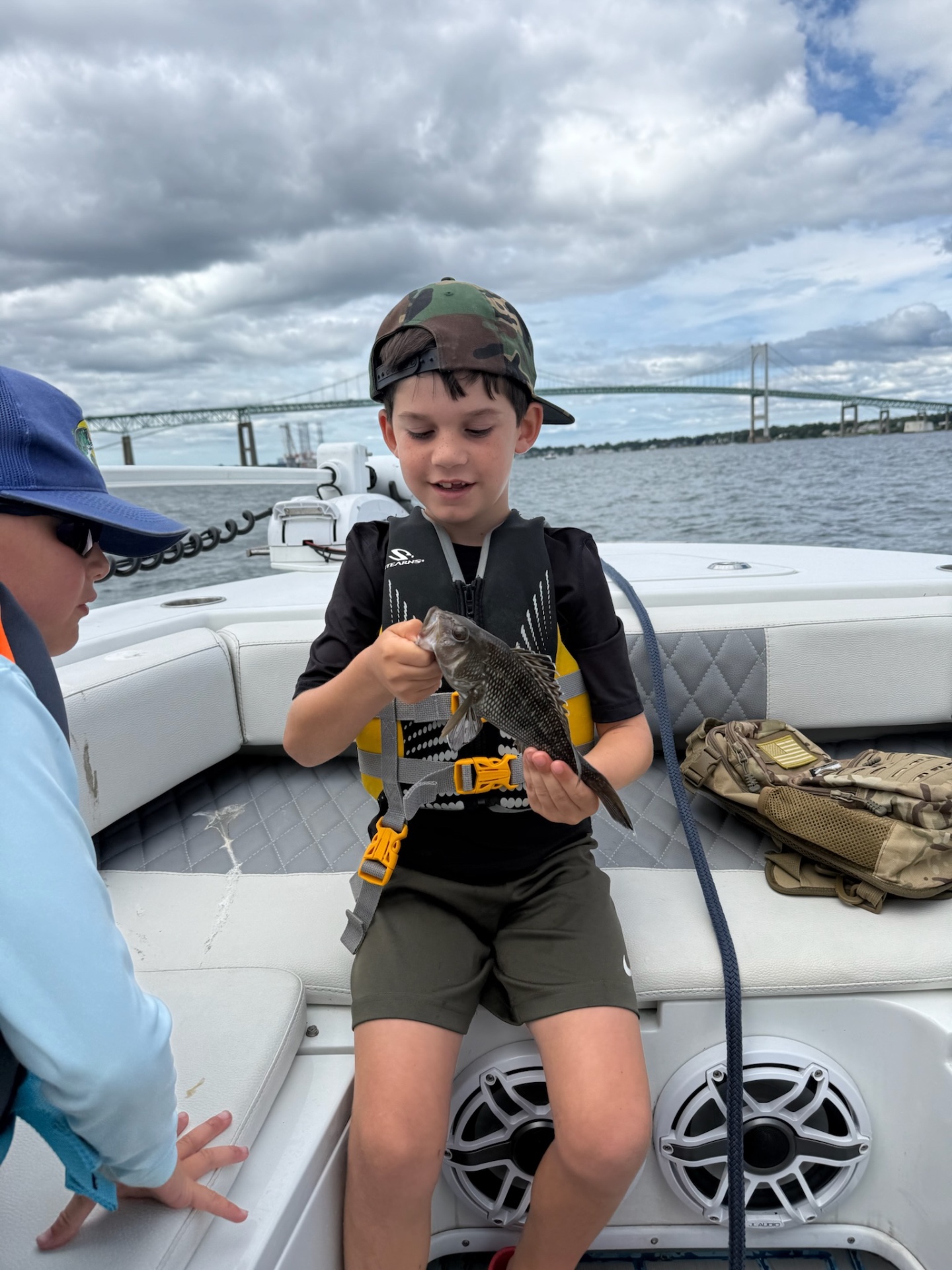 Academy camper with a black sea bass by the bridge