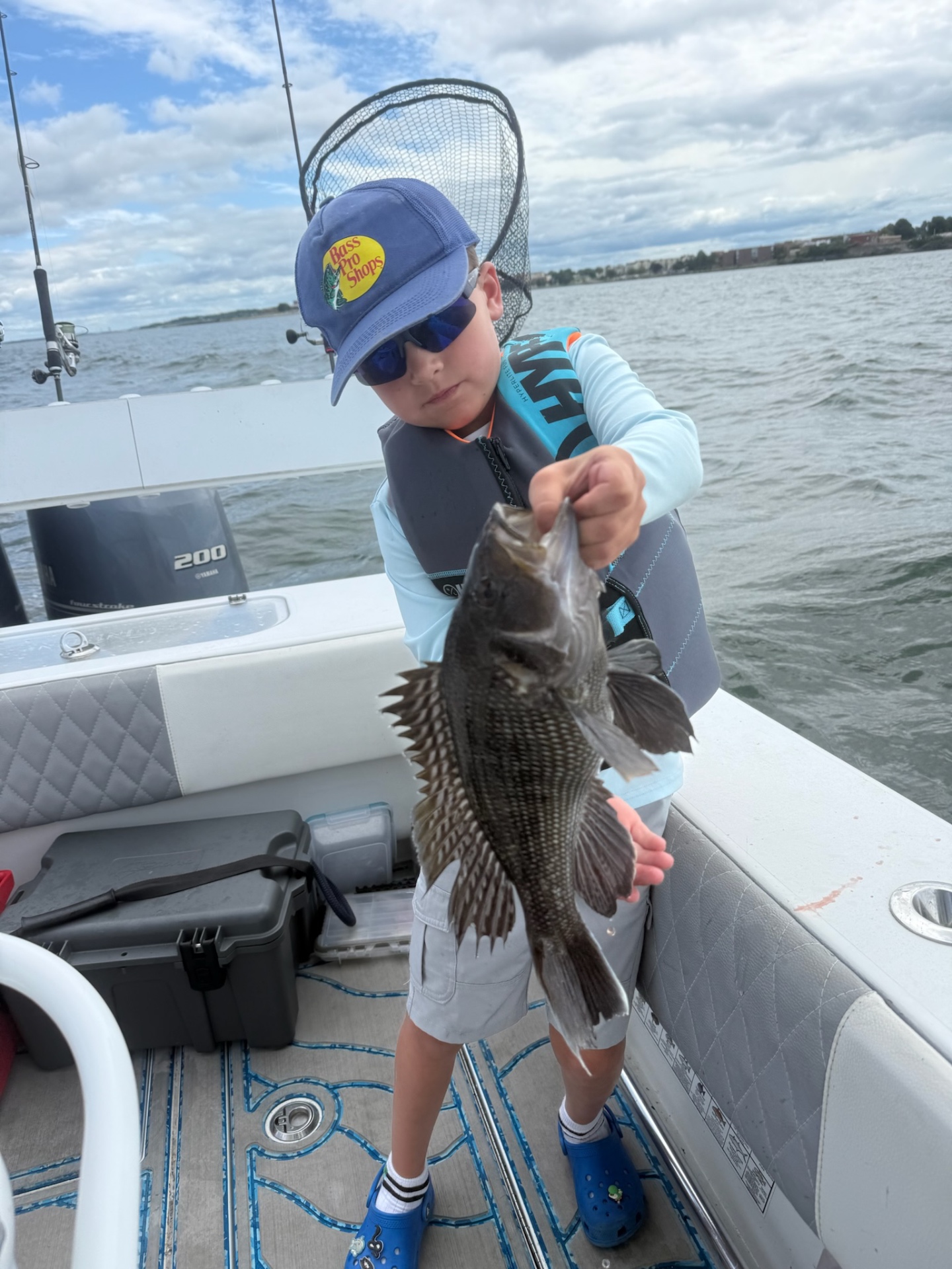 Academy camper with a black sea bass and net