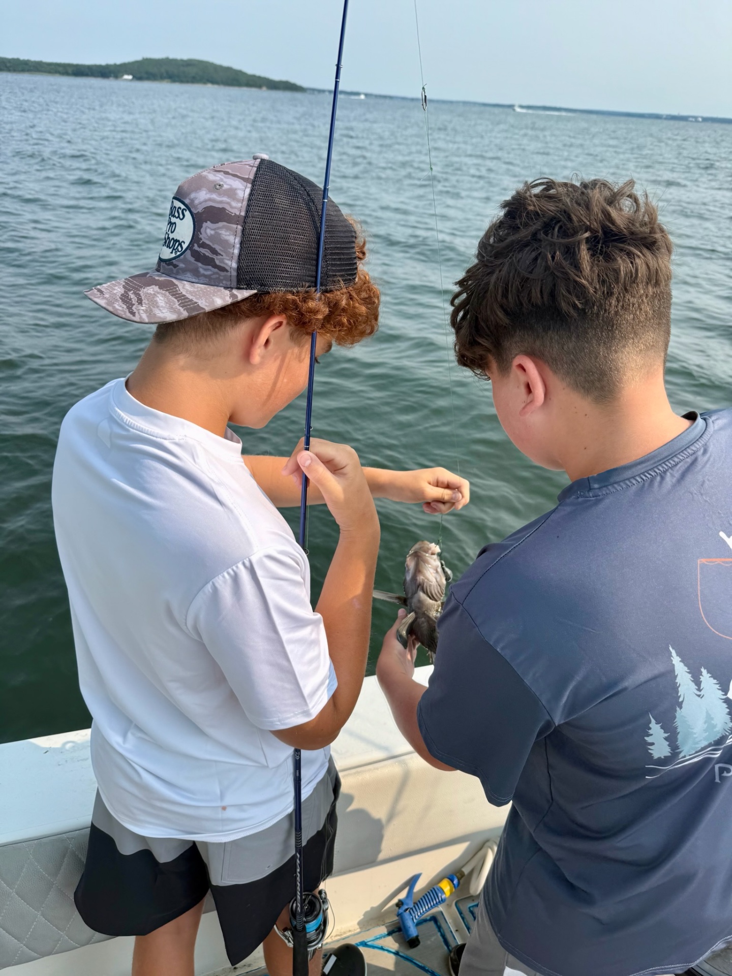 Academy campers unhooking a fish