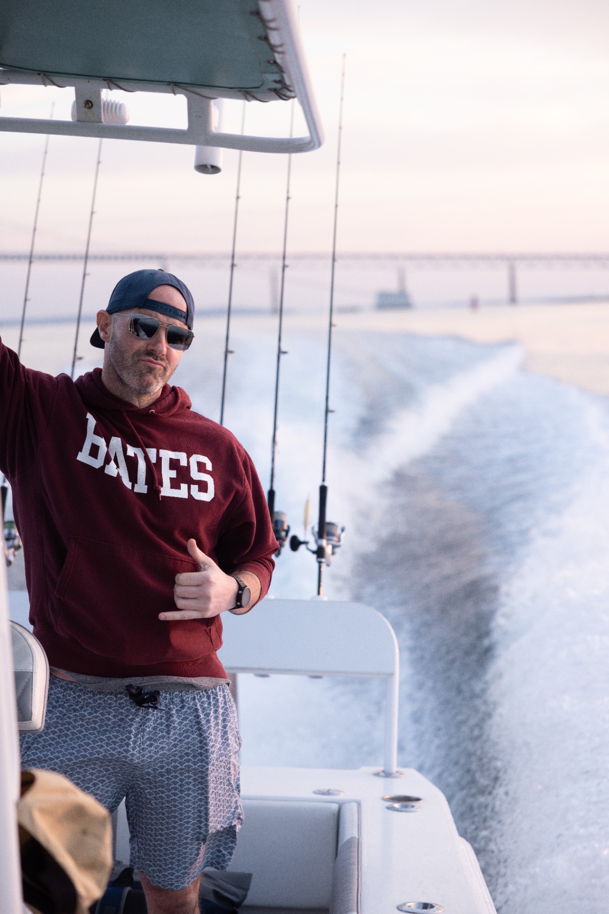 Captain in a Bates hoodie running back to port