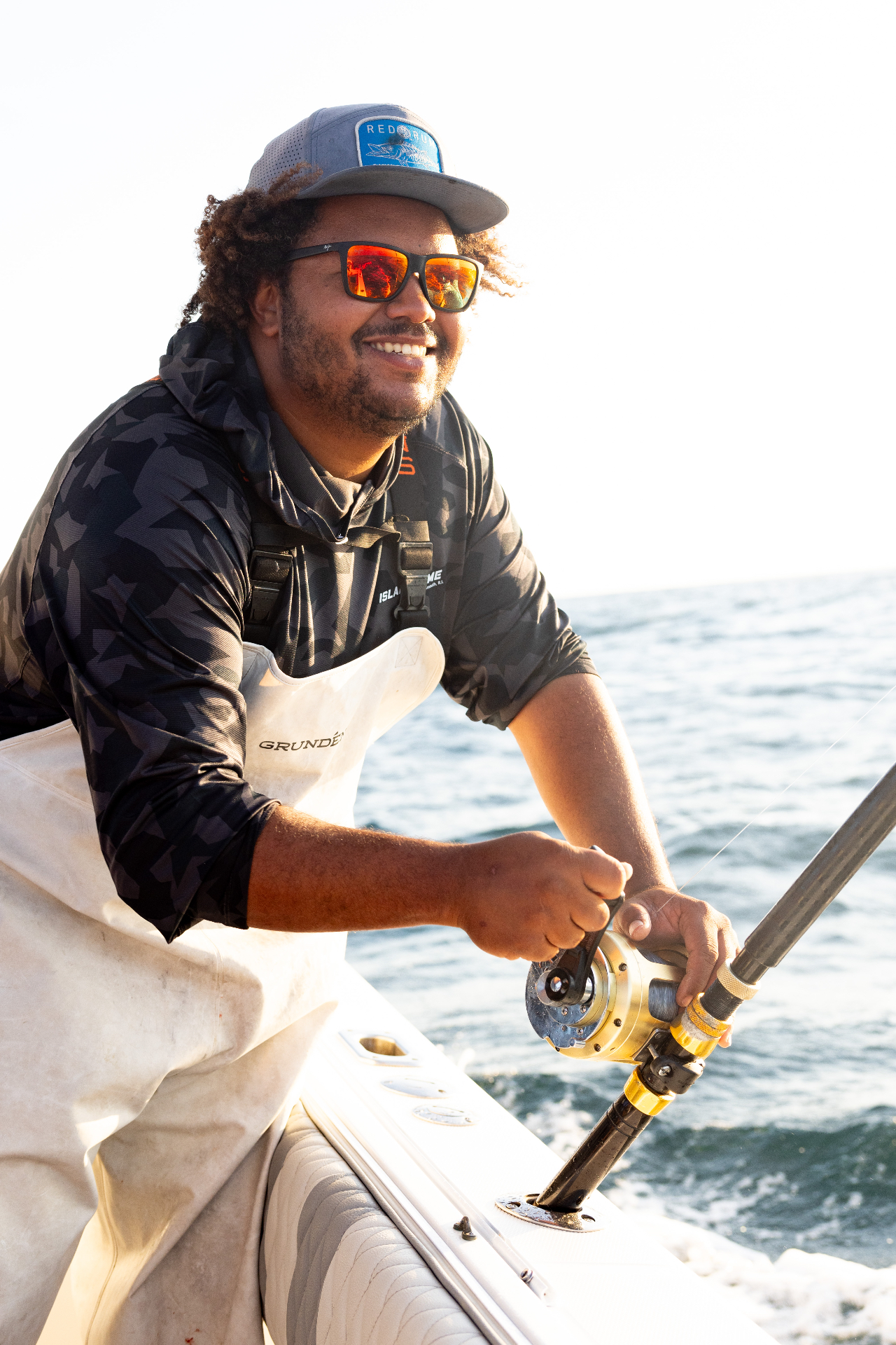 Angler cranking the reel on an offshore tuna